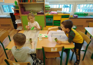 dzieci z gr 2 robią kwiatki dla dziadków