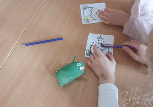 Dzieci wykonują żabki z rolki po papierze