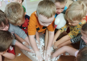 Dzieci uczestniczą w zabawie badawczej „Sztuczny śnieg”.
