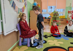 Chłopiec składa życzenia jubilatce