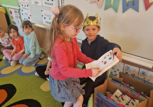 Dziewczynka składa życzenia jubilatowi i otrzymuje upominek