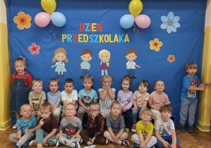 Dzieci z gr 1 pozują na tle dekoracji