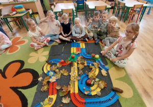 Dzieci z gr 4 prezentują drzewo zrobione z plastikowych elementów