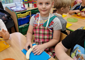 Chłopiec kroi banana