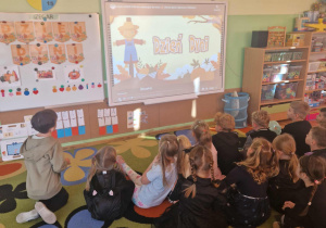 Dzieci oglądają film edukacyjny o dniu dyni