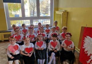 Dzieci z gr 4 trzymają w ręku czerwone serduszka