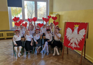 Dzieci z gr 4 trzymają w ręku czerwone serduszka
