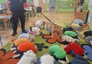 Dzieci ćwiczą pozycję bezpieczną żółwia