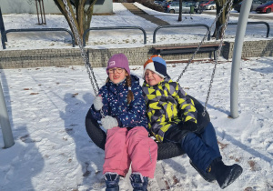 Dwoje dzieci huśta się na bosianim gnieździe