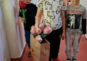 Chłopcy z kwiatami udają się do Pań pracujących w przedszkolu