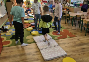 Dzieci uczestniczą w zabawie z torem przedszkód