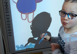 Dziecko rysuje misia na tablicy