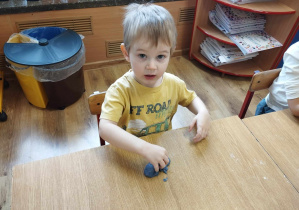 Chłopiec bawi się masą slime.